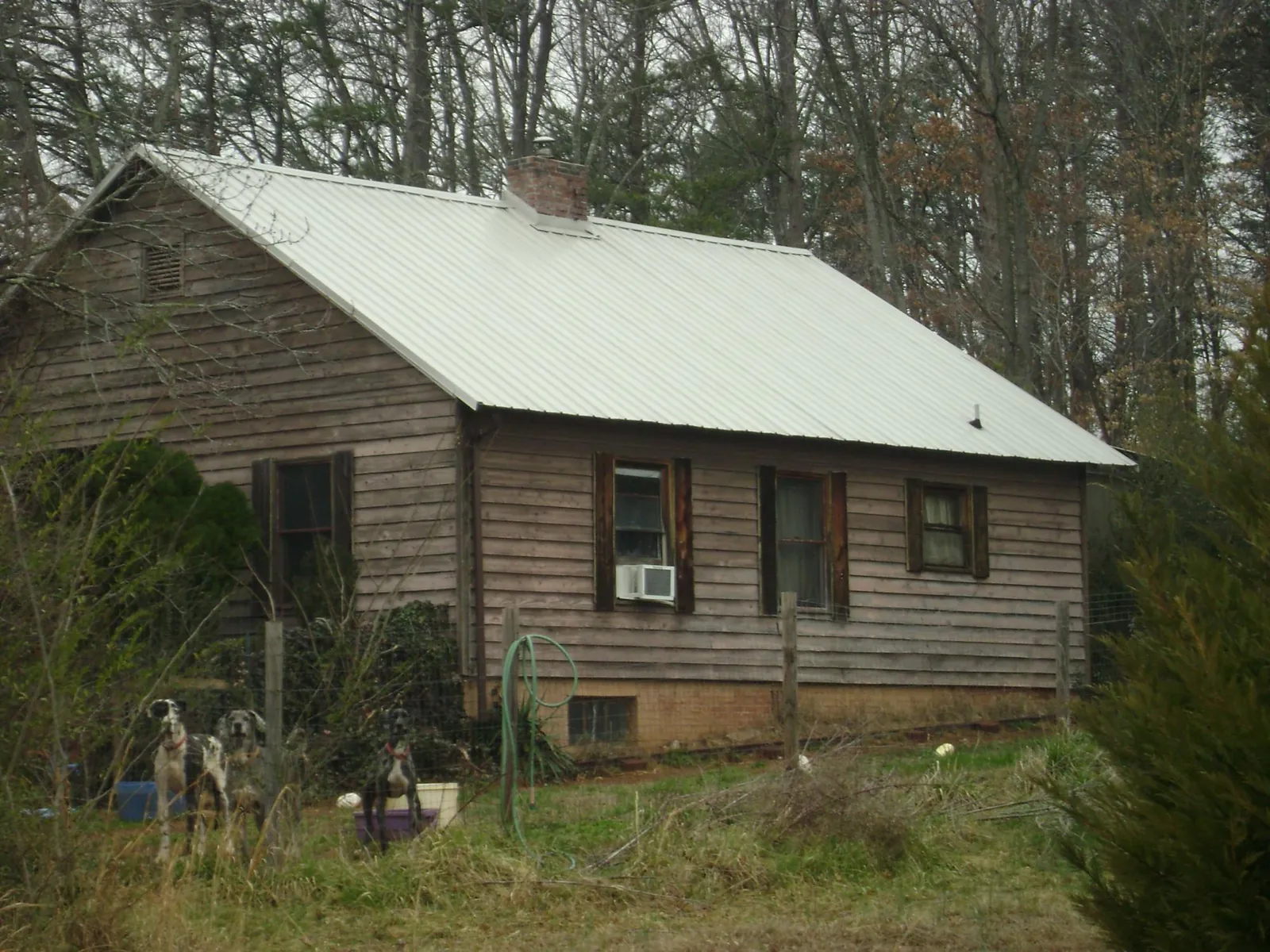 White metal roof on an old wood sided farmhouse, from a Metal Roof Installation job in Mercer